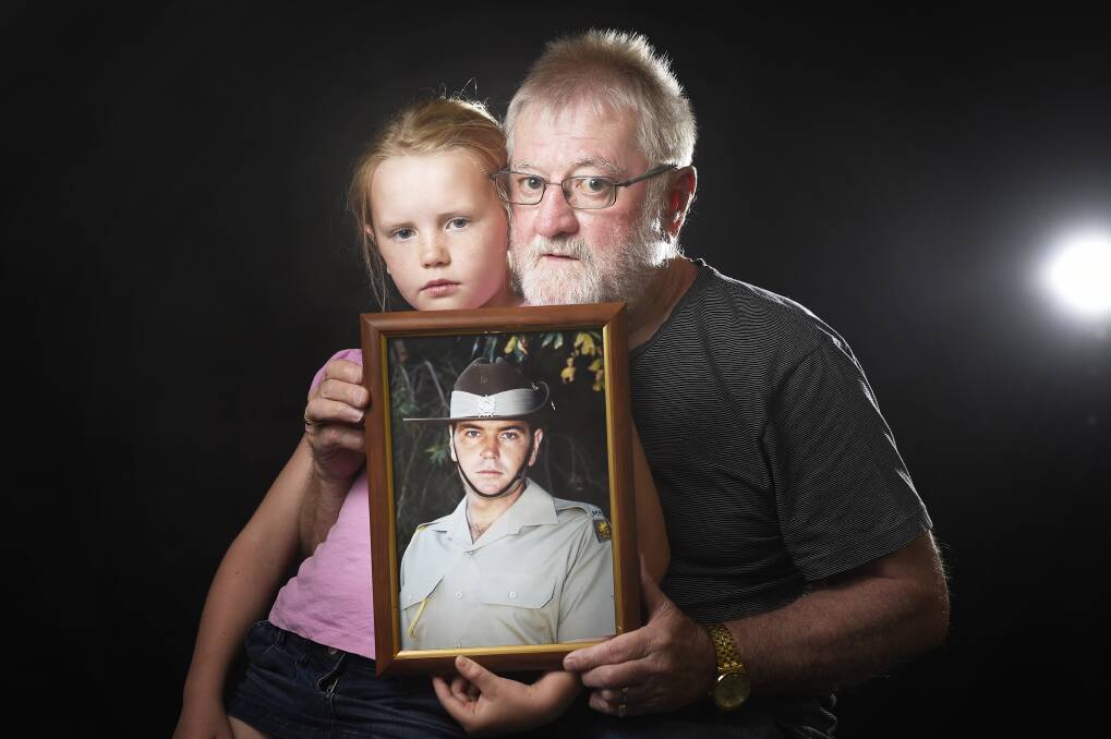 We need to change our thinking: John Shanahan and granddaughter Harriette Preston, 7, with a photograph of Nathan. Picture: Luka Kauzlaric.