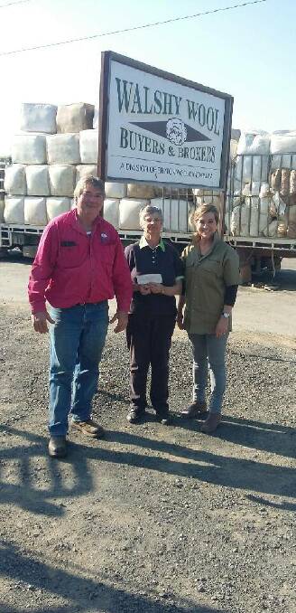 Gail Hanigan president of Can Assist receiving a cheque from Celia Walsh and Geoffrey Beath from Bryton Wool.