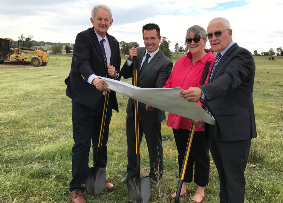 Greg Conkey, Paul Toole, Linda Inwood and Chris Edwards looking
at the plans for the new track and facilities at Wagga. Photo: Supplied.
