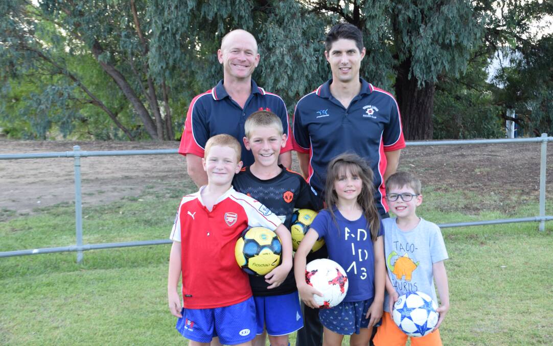KICKING OFF: Six-a-side coordinator Glenn Payne and YLSC treasurer David Brouwer with Liam and James Payne, Madeleine and Nicholas Brouwer. Photo: Supplied.