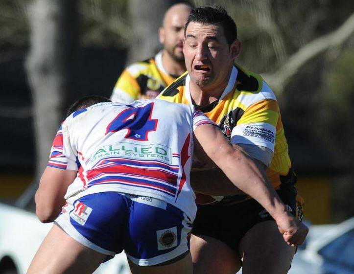 BIG HIT: Gundagai centre Damian Willis feels the heavy tackle of Young counterpart Mitch Ryan during the Tigers' big win at Anzac Park on Sunday. Picture: Laura Hardwick.