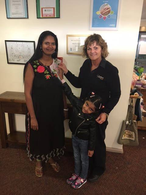 SPECIAL DAY: Silpa Chaparala with daughter Twinkle receiving her badge from Lifestyle Coordinator Camille Williams. Photo: Supplied.