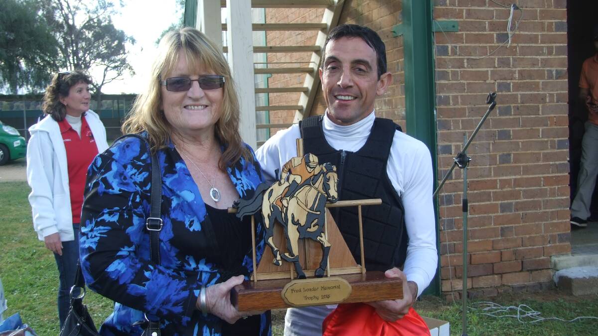 Karen Loader presenting Tony Cavallo with the Fred Loader Memorial Trophy for Most Successful Jockey at the 2015 race day.