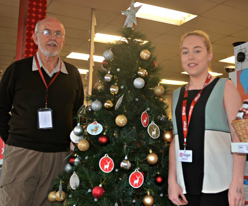Sharing the spirit: UnitingCare Coordinator, Bob Lloyd and Target Country Manager, Brodie Shelton with the UnitingCare and Target Christmas tree.