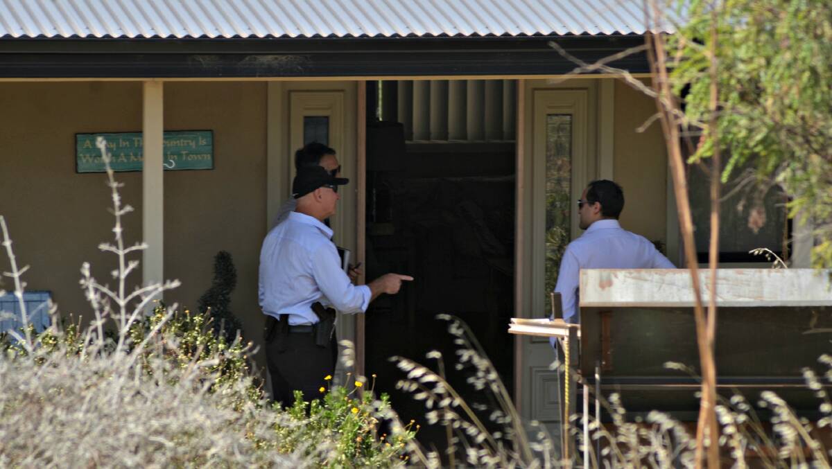 AFP Officers could be heard using tools inside the house as they continue their search of the property. Photos: Rebecca Hewson and Craig Thomson.