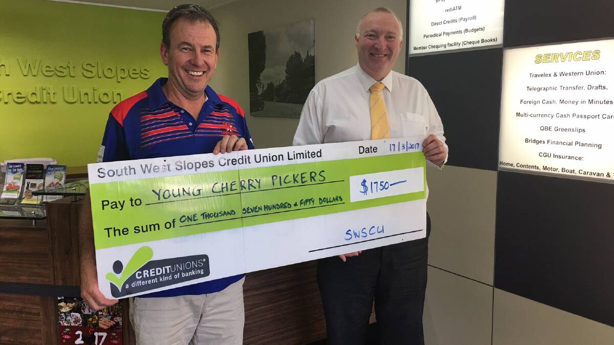 TRY: The South West Slopes Credit Union has presented a cheque to Young Rugby League Football Club. Photo: Supplied.