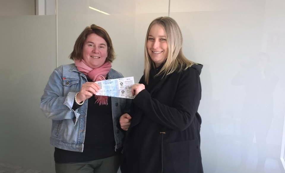 WINNER: Trish Patterson presenting Kathryn Eastlake with her tickets.
