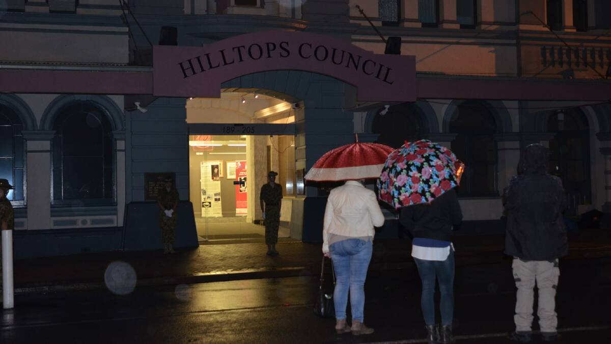 LEST WE FORGET: The rain was coming down but that didn't stop local residents from paying their respects at the Dawn Service in Young on Tuesday morning. Photo: Rebecca Hewson.