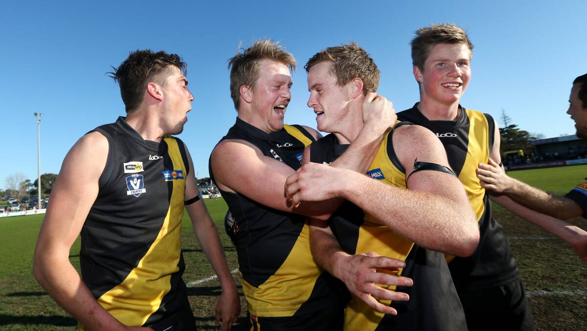 Seamus Blake, second from right, celebrates winning the 2014 WDFNL grand final against Panmure with his Merrivale teammates. Picture: Aaron Sawall