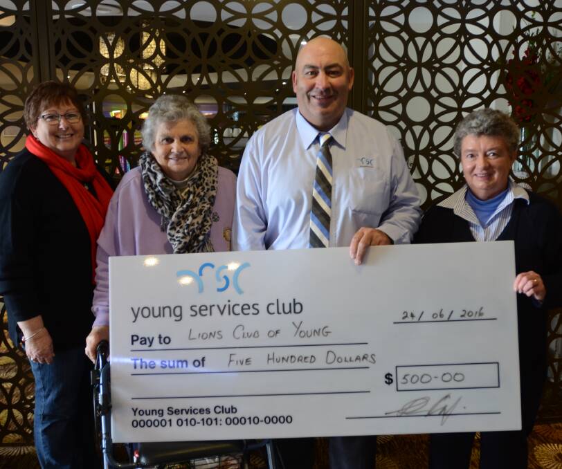 Lions Club of Young members Marie Tame, Jan Gorman and Helen Sell were presented with a cheque by Young Services Club Duty Officer Brad Pettit. 