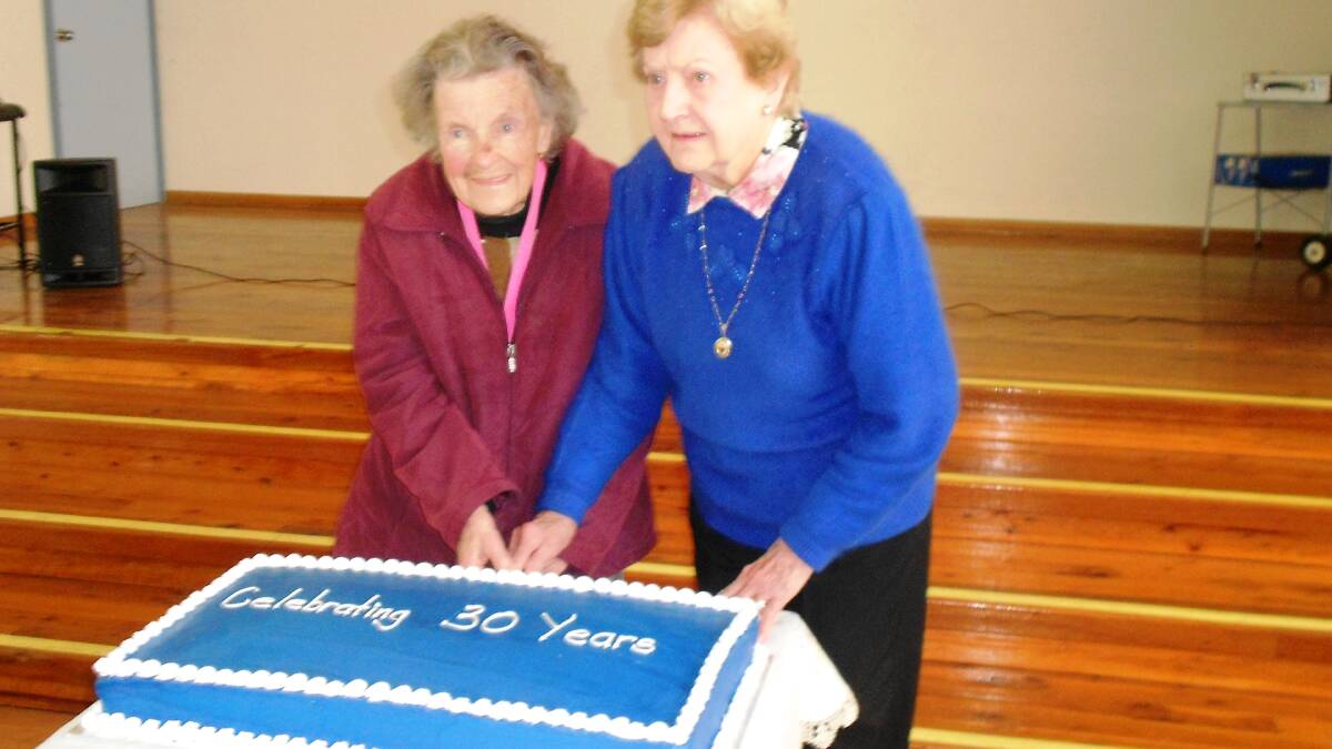 Client of 30 years Joan Swan and Committee Member  and original Co-ordinator Margaret Phelan cut the Birthday Cake.