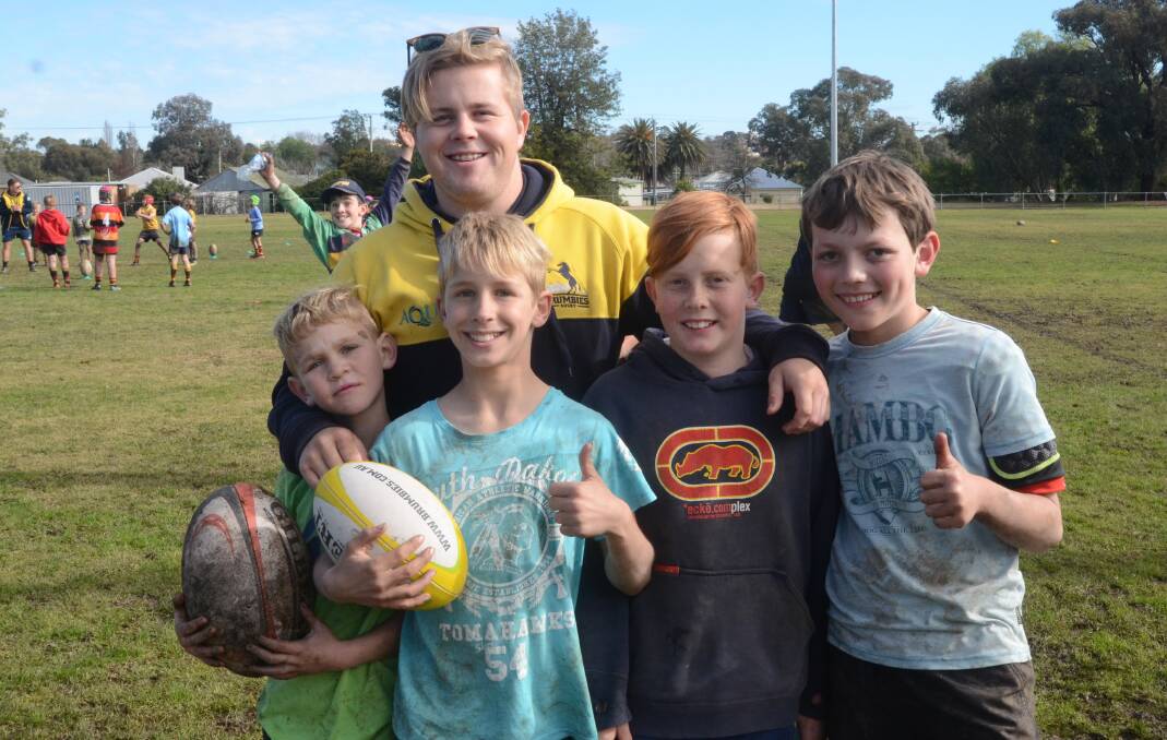 SMILES: Sam Newell, Albie Dowling, Jack McIllhatton and Dan Smith with Brumbies Development Officer Seth Stoltenberg.