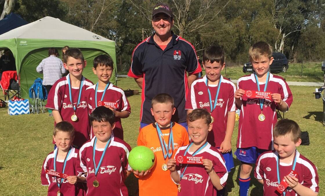 PROUD: Young's Under 9 soccer team at the Cowra carnival on the weekend with coach Paul Cameron.