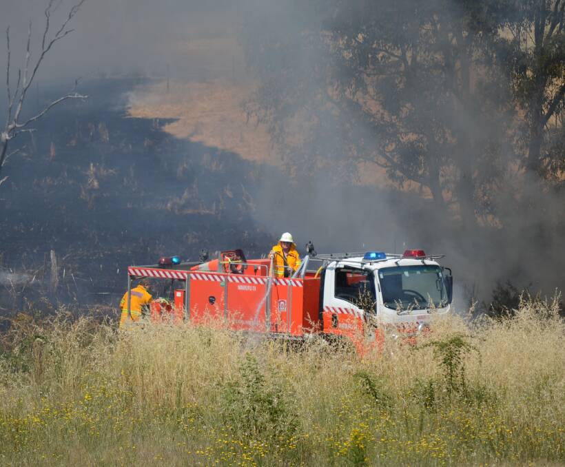 FIRE: A Rural Fire Service crew in action at the Temora Road fire on Tuesday morning. 