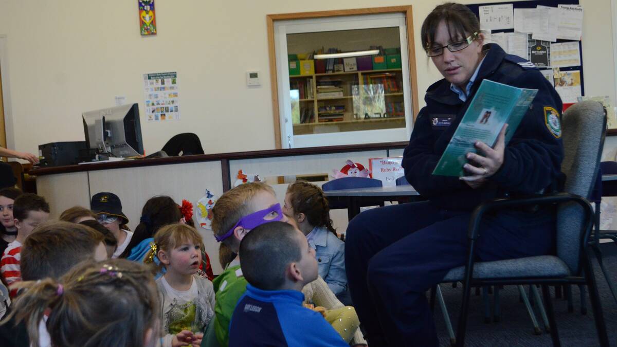 WORKING WITH KIDS: Acting Inspector Marshall reading to school children in Young.