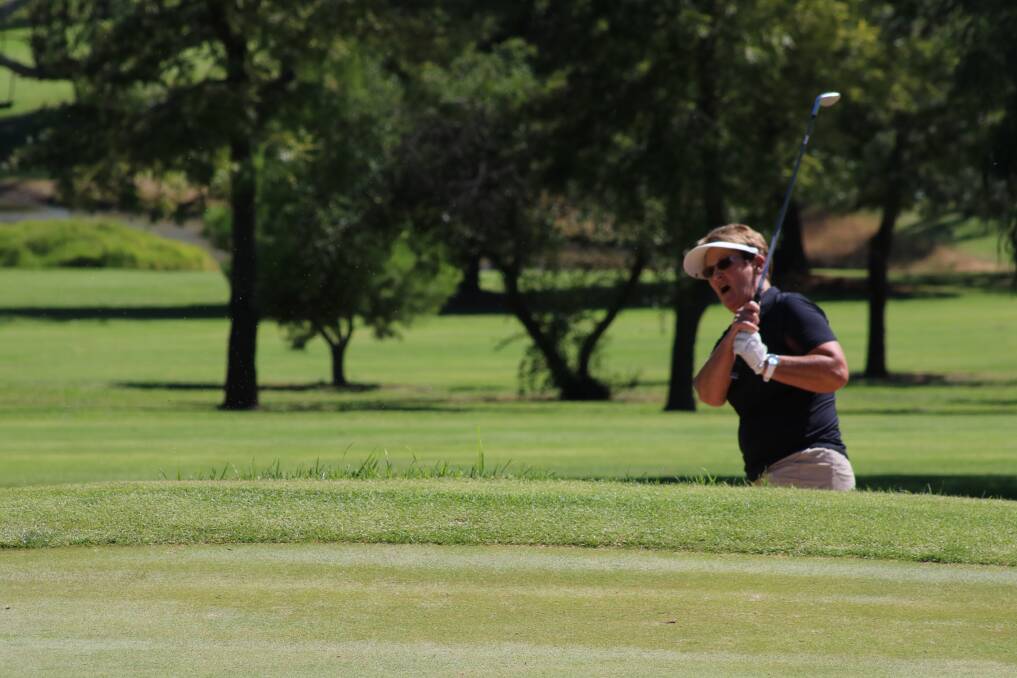 OUT OF THE SAND: Women's golf action from the Young golf club. Noella Hardman hits one out of the bunker.