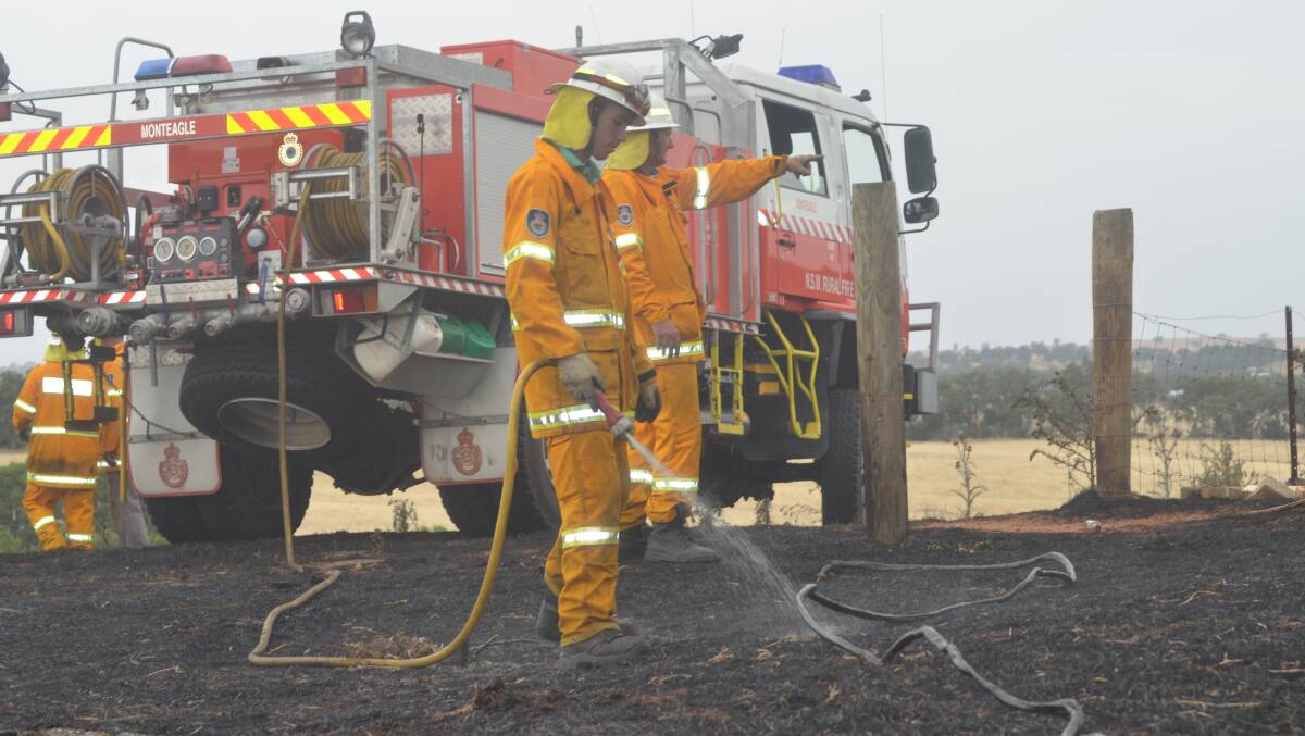 PUTTING OUT THE FIRE: New South Wales Rural Fire fighters. Picture: Craig Thomson.