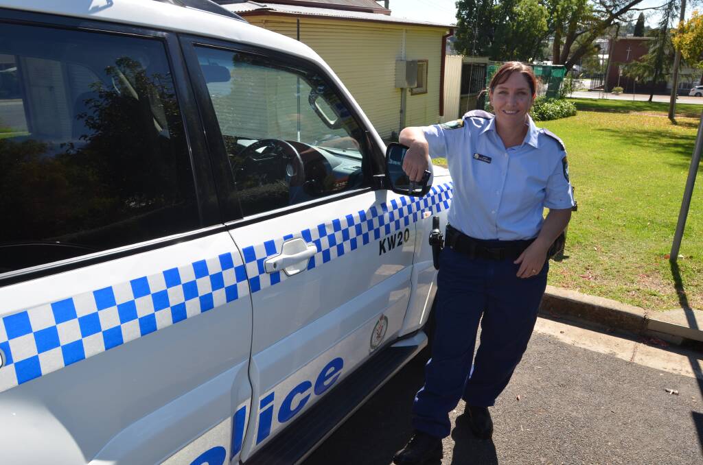 PROUD POLICEWOMAN: Acting Inspector Marshall with a police vehicle that is her 'office'. Picture: Craig Thomson.