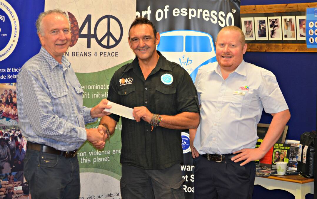 Perfect blend: Adrian Capra hands a cheque for $1200 to Hilltops Suicide Prevention Network Chair Eris Gleeson whilst Hilltops Council's David Newberry looks on. 