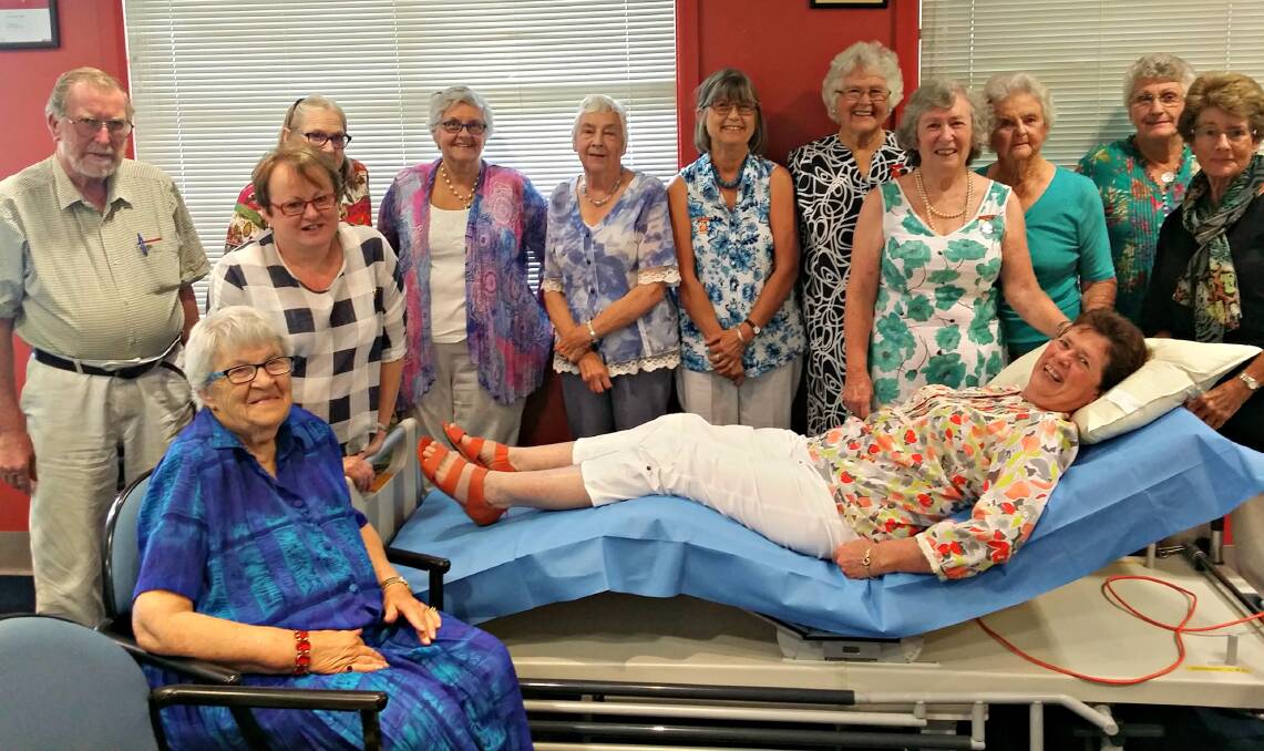 Bedridden: Hospital Auxiliary members and Sandra Latham try out the trauma bed they decided to buy for the emergency department. Picture: Supplied.