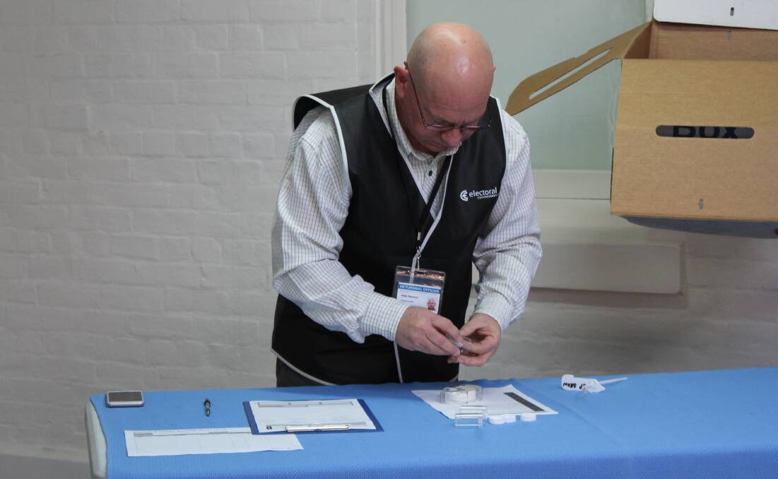 Number cruncher: Returning Officer Peter Seymour picks a candidate from the ballot box.