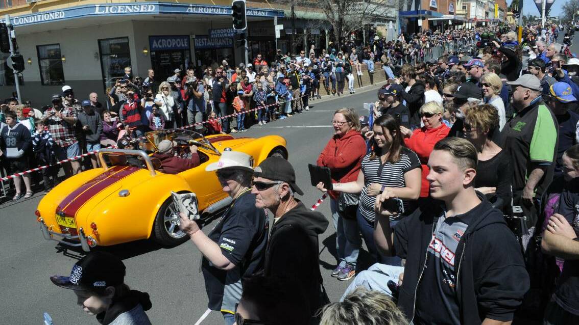 Race fans lined the streets to watch the Supercar Transporter Parade as the trucks and drivers made their way up William Street on Wednesday morning. Photo: CHRIS SEABROOK