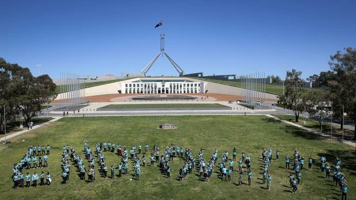 More than 350 young Australians form the words End Poverty on the lawns in front of Parliament House. Photo: Jeffrey Chan