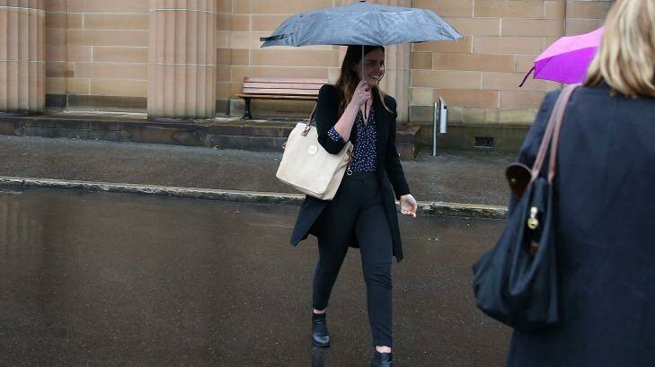 Lucy McNamara attempts to evade the media after Friday's sentencing. Photo: Anthony Johnson