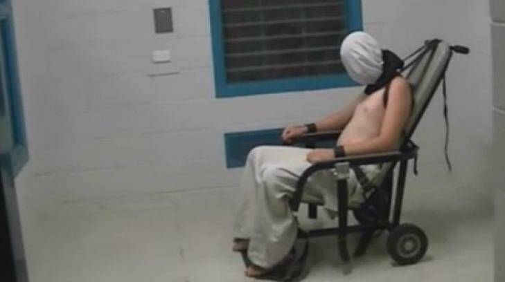 A teenage Dylan Voller has a hood placed over his head and is strapped to a chair at the Don Dale Detention Centre in the NT. Photo: Four Corners