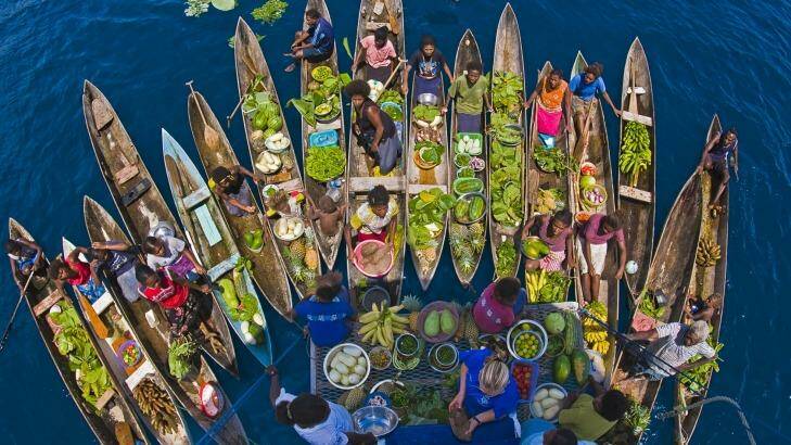 A boat market visits a cruise ship in the Solomon Islands.

 Photo: Rodger Klein