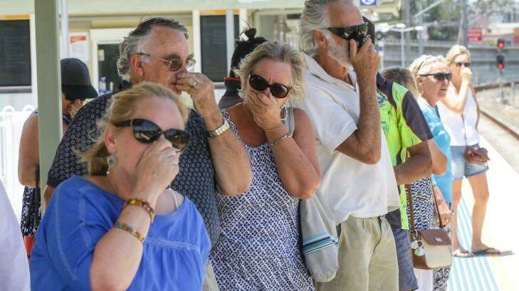 Local residents try to block the smell emitting while waiting for a train at Mulgrove Station  Photo: Dallas Kilponen