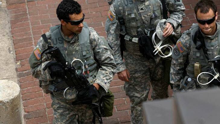National Guard troopers carrying plastic handcuffs on the streets of Baltimore. Photo: Trevor Collens