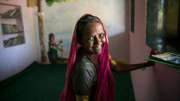 70 year old Sevanta Shantaram Kedar poses for a photo in her school. Her family was too poor to send her to school when she was growing up.  Photo: Allison Joyce/Newslions