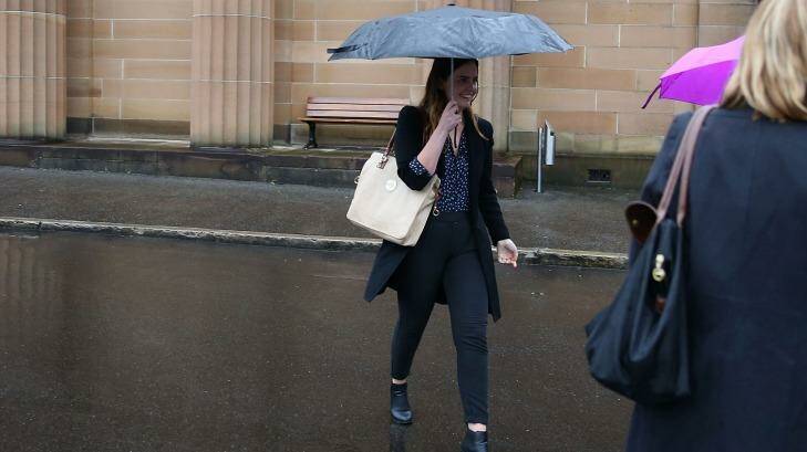 Lucy McNamara tries to evade the media after Friday's sentencing. Photo: Anthony Johnson