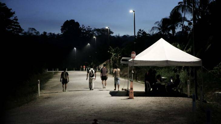 Refugees pass the security check point as they return to the East Lorengau Transit Centre on Manus Island. Photo: Andrew Meares