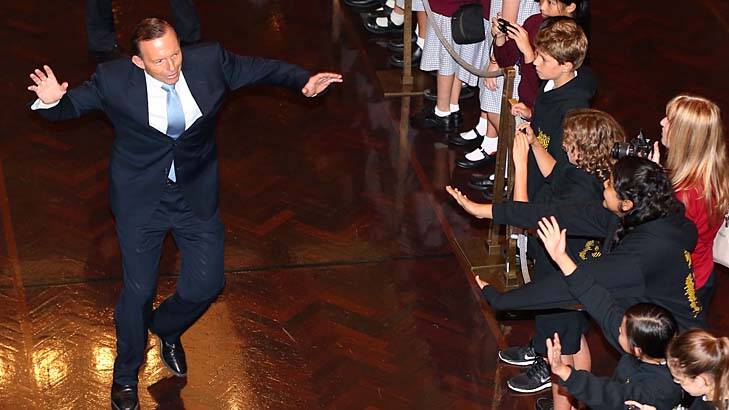 A step to the left: Prime Minister Tony Abbott gives young visitors to the Great Hall an offbeat welcome. Photo: Alex Ellinghausen