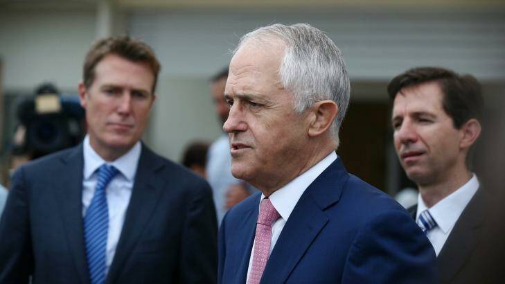 Prime Minister Malcolm Turnbull, flanked by ministers Christian Porter and Simon Birmingham, called on Cory Bernardi to quit his senate spot on Wednesday. Photo: Alex Ellinghausen