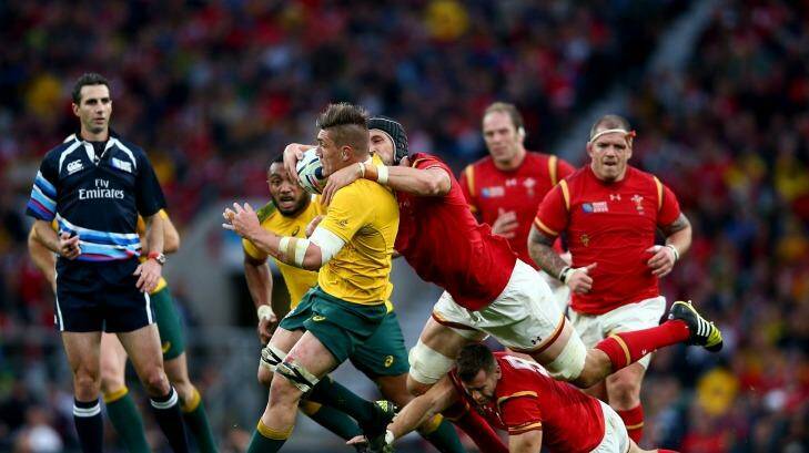 Reeled in: it took plenty from Wales to stop Wallabies revelation Sean McMahon.
 Photo: Paul Gilham