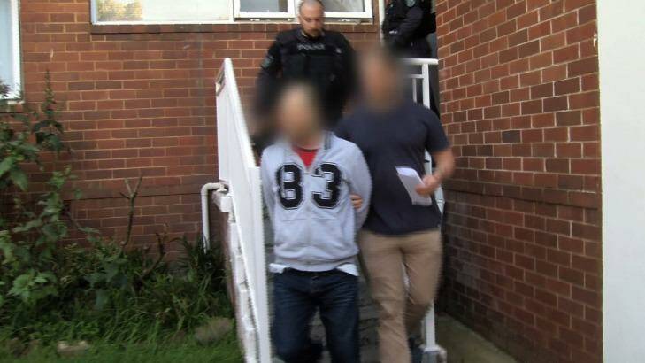 Police arrest a man during raids on drug suppliers in Sydney. Photo: Police Media