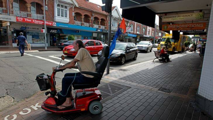 A man rides an electric mobility scooter in Sydney. Photo: Ben Rushton