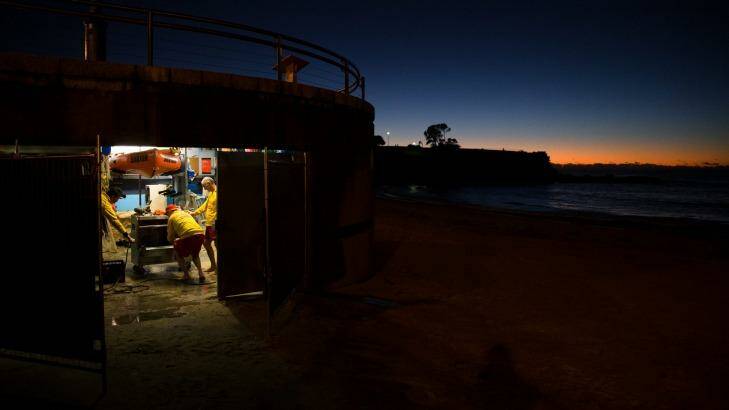 Members of the Coogee Surf Life Saving Club clear out their boatshed which was inundated with water and sand during the storms. Photo: Janie Barrett
