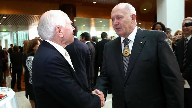 Former prime minister John Howard greets Sir Peter at the ceremony. Photo: Alex Ellinghausen