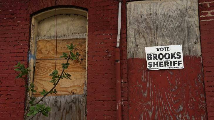 An election poster on a boarded-up house in Hollins Market, Baltimore. Photo: Trevor Collens