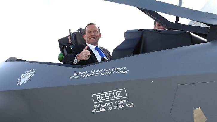 Former prime minister Tony Abbott poses in the cockpit of a replica of the F-35A Lightning II Joint Strike Fighter at Canberra's Fairbairn Airbase in April 2014.   Photo: Alex Ellinghausen