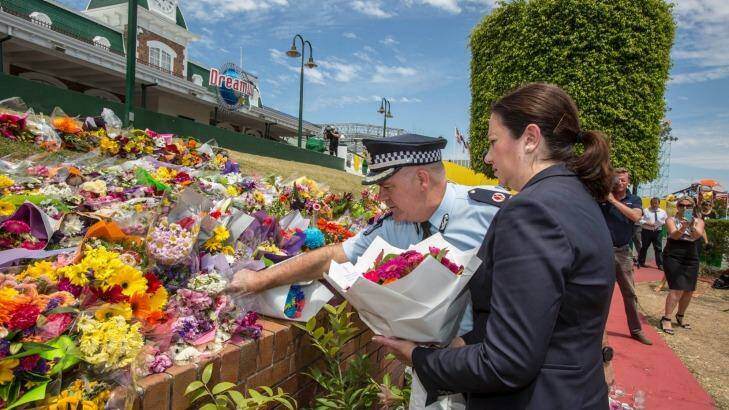 Queensland Premier Annastacia Palaszczuk and police assistant commissioner Brian Codd pay their respects at Dreamworld. Photo: Glenn Hunt