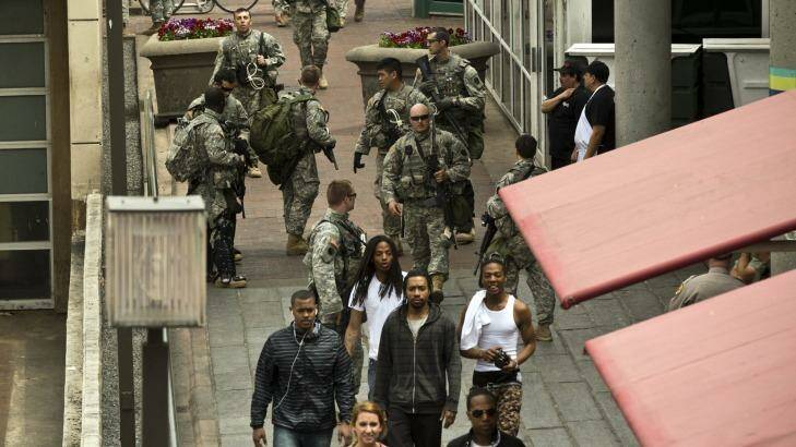 National Guard troopers and civilians in Baltimore's harbour area. Photo: Trevor Collens