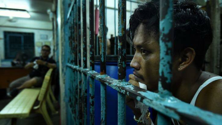 Wounded drug user Francisco Maneja in a cell at Manila police headquarters.  Photo: Kate Geraghty