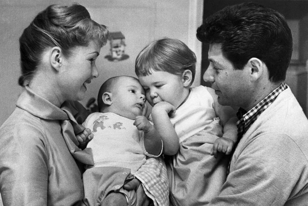 Two and one half month old Todd Emanuel Fisher meets the rest of the family here for the first time in front of a camera. Photo: Bettmann
