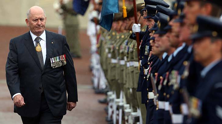 Rain on the parade: Sir Peter Cosgrove inspects the guard of honour as part of his official swearing in as Australia's new Governor-General at Parliament House, Canberra, on Friday. Photo: Andrew Meares