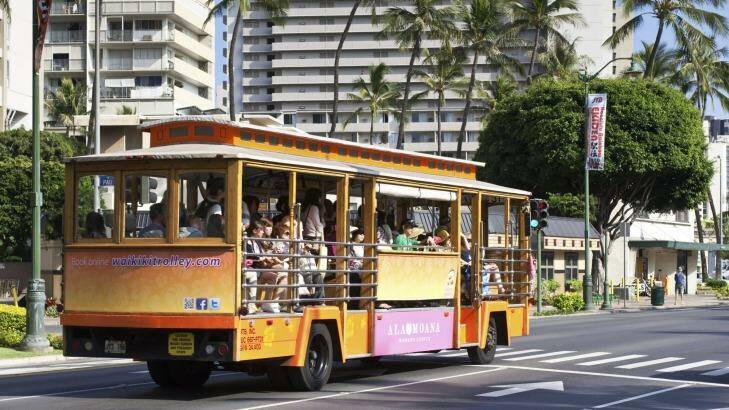 Riding the Ala Moana Shopping Centre Trolley down Kalakaua Avenue in Waikiki. Photo: iStock